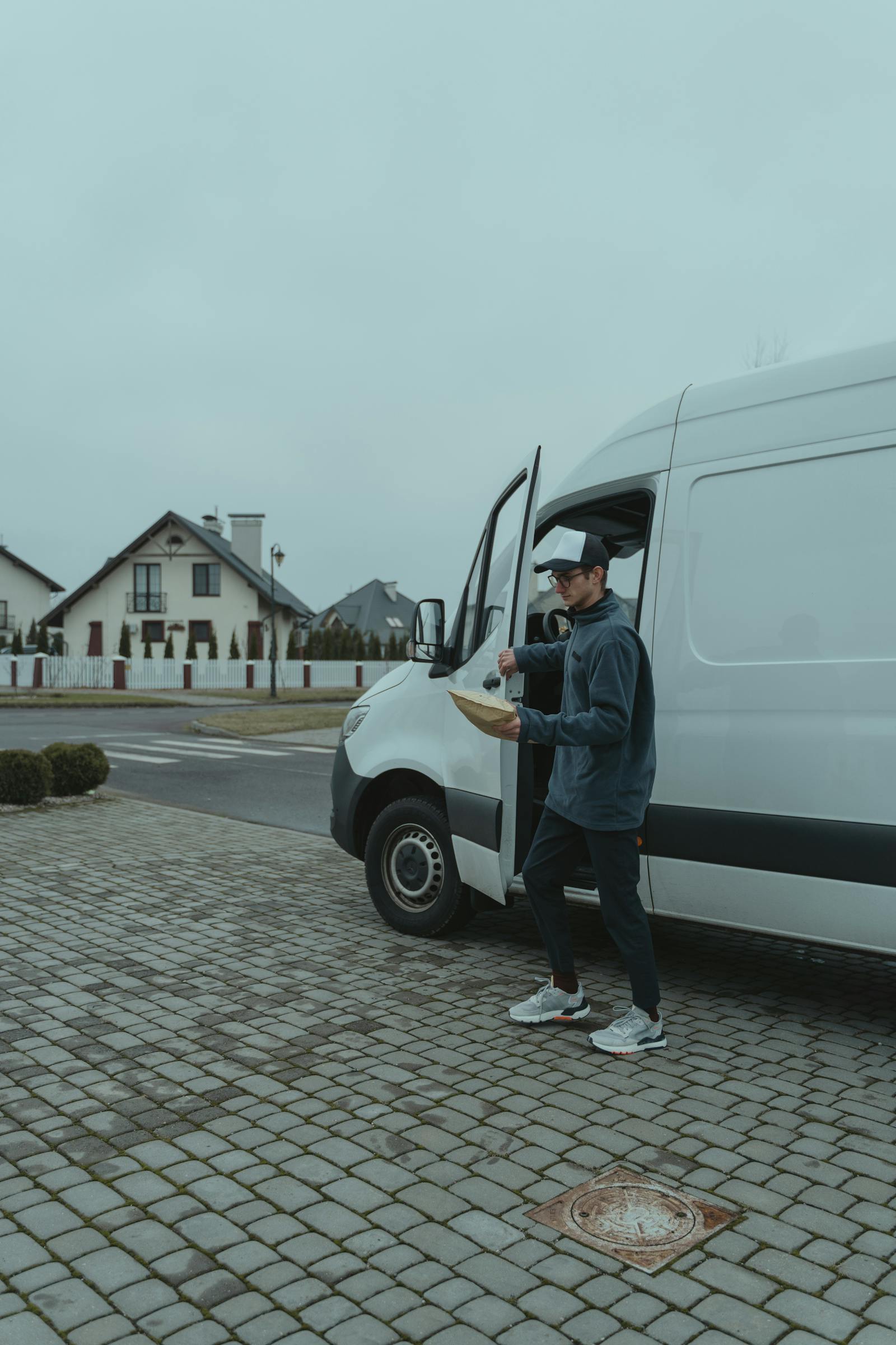 Delivery team member carrying a parcel through a Sydney suburb
