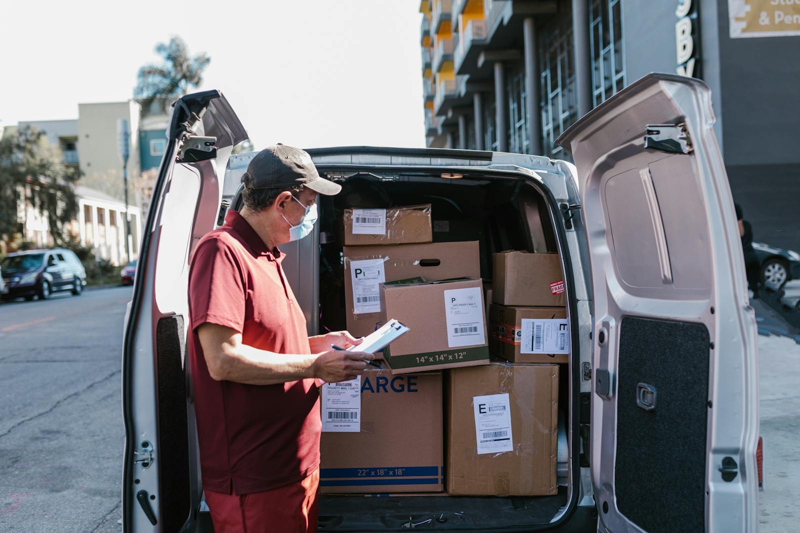 Team member checking parcels inside a delivery van