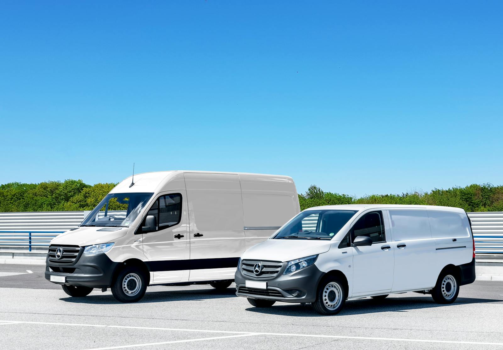 Two white delivery vehicles prepared for service